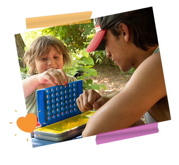 girl and staff member playing connect 4
